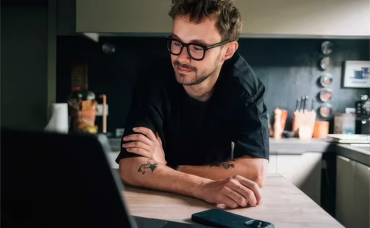Man with glasses front of laptop