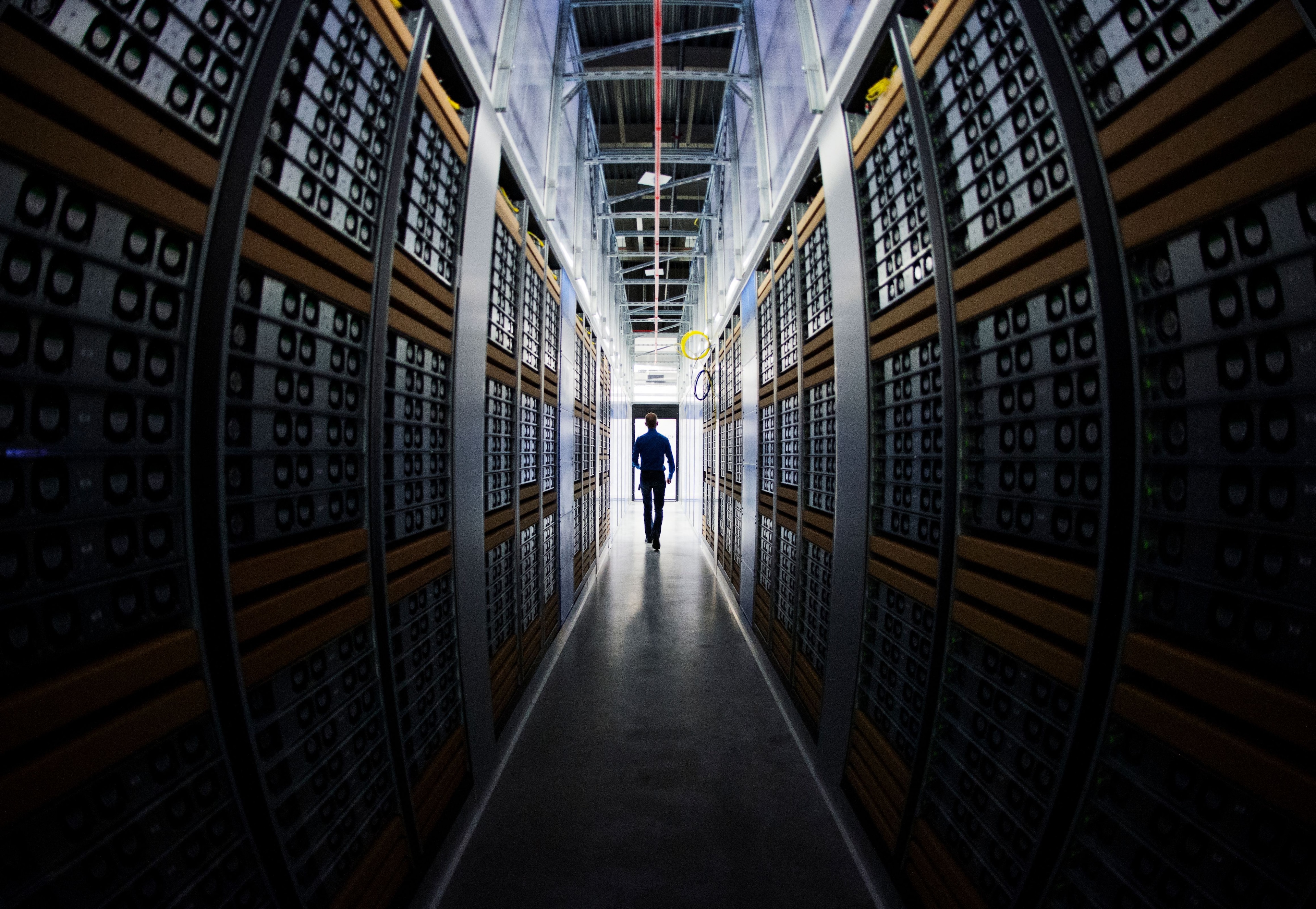 Data Center Manager walks in server rooms