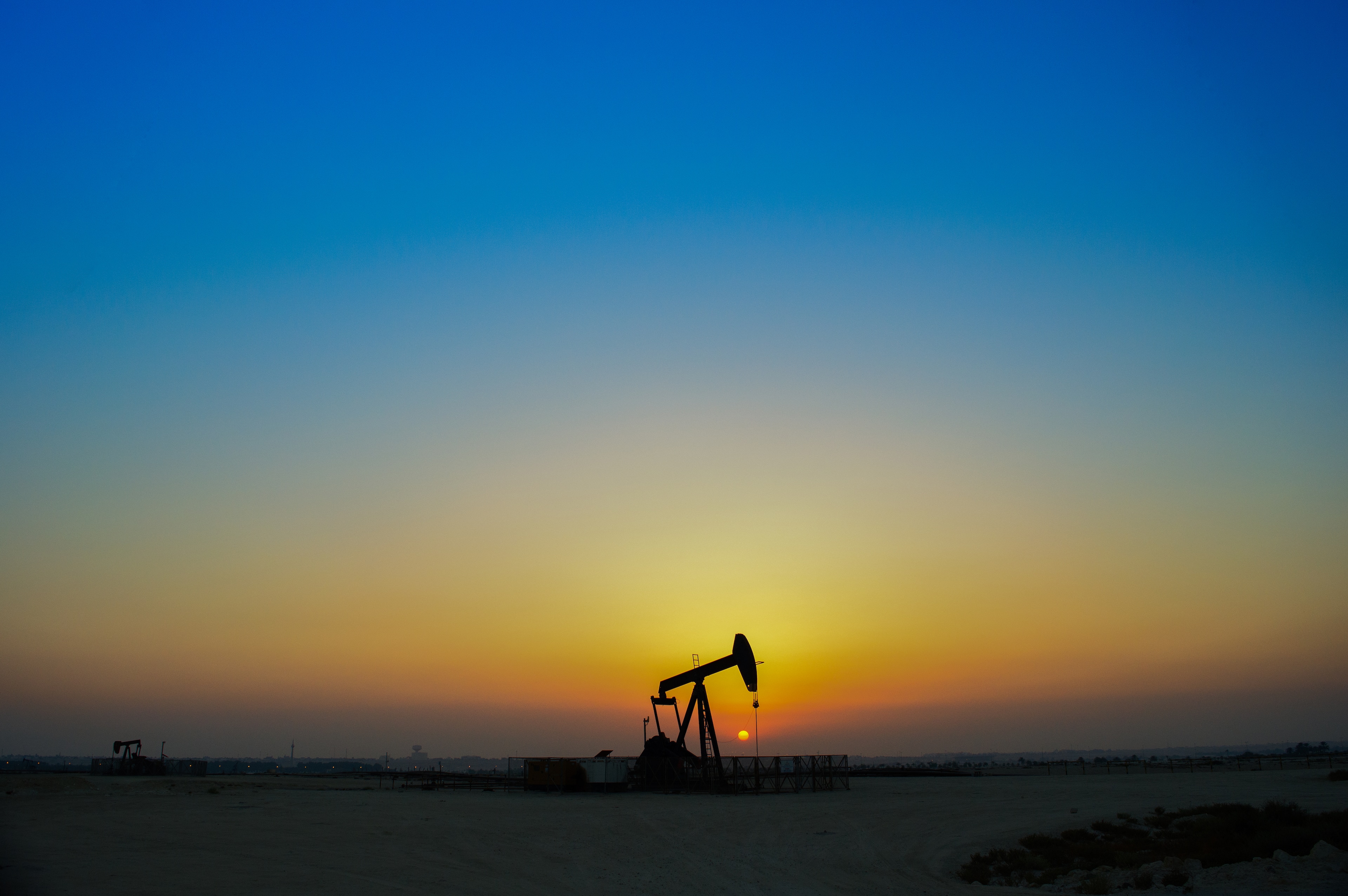 Oil well in sunrise
